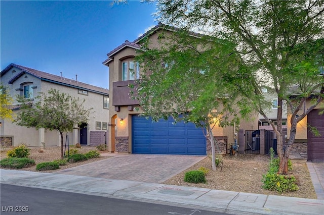9327 S Chieftain St, Las Vegas, NV 89178 - obstructed view of property with stucco siding, driveway, a gate, fence, and an attached garage