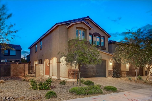 9327 S Chieftain St, Las Vegas, NV 89178 - mediterranean / spanish home with stucco siding, an attached garage, a gate, driveway, and fence