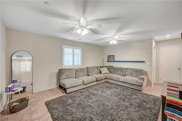 9327 S Chieftain St, Las Vegas, NV 89178 - carpeted living room with a ceiling fan, plenty of natural light, baseboards, and a textured ceiling