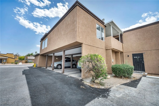 1424 Santa Anita Dr Unit D, Las Vegas, NV 89119 - view of home's exterior with stucco siding and covered parking
