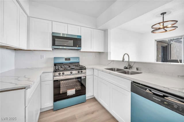 1424 Santa Anita Dr Unit D, Las Vegas, NV 89119 - kitchen with stainless steel appliances, a sink, white cabinets, and tasteful backsplash