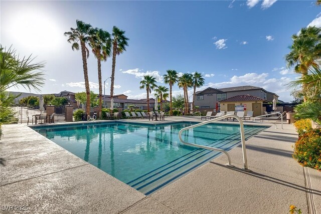 680 Moonlight Stroll St, Henderson, NV 89002 - community pool with fence, a patio, and a residential view