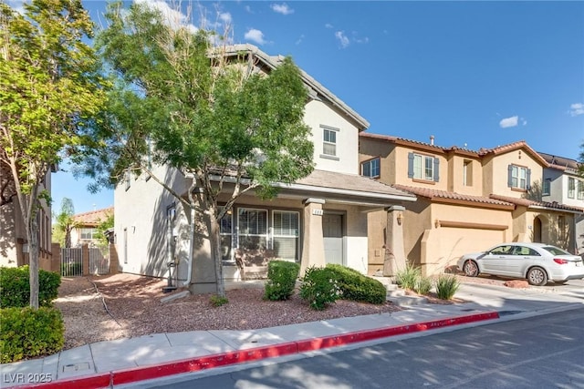 680 Moonlight Stroll St, Henderson, NV 89002 - view of front of house featuring stucco siding, an attached garage, a gate, a tiled roof, and fence