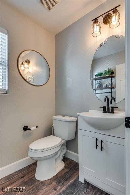 680 Moonlight Stroll St, Henderson, NV 89002 - half bath with baseboards, toilet, wood finished floors, and vanity