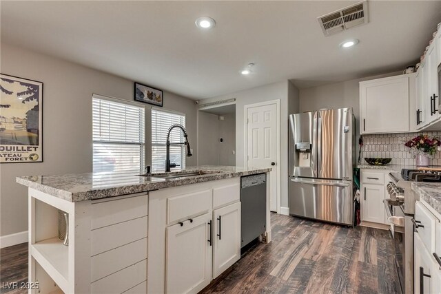 680 Moonlight Stroll St, Henderson, NV 89002 - kitchen featuring stainless steel appliances, a sink, dark wood-style flooring, decorative backsplash, and white cabinetry