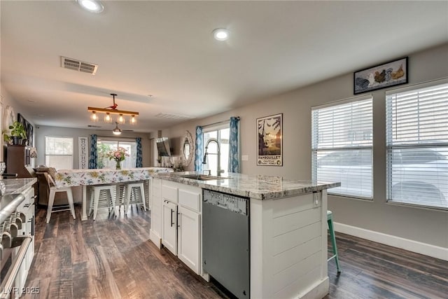 680 Moonlight Stroll St, Henderson, NV 89002 - kitchen with dishwasher, a sink, white cabinets, dark wood-style floors, and light stone counters