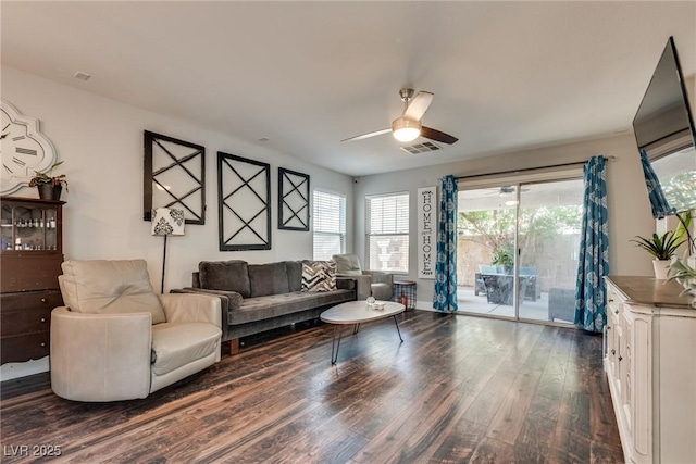 680 Moonlight Stroll St, Henderson, NV 89002 - living area with dark wood-style floors, healthy amount of natural light, and a ceiling fan