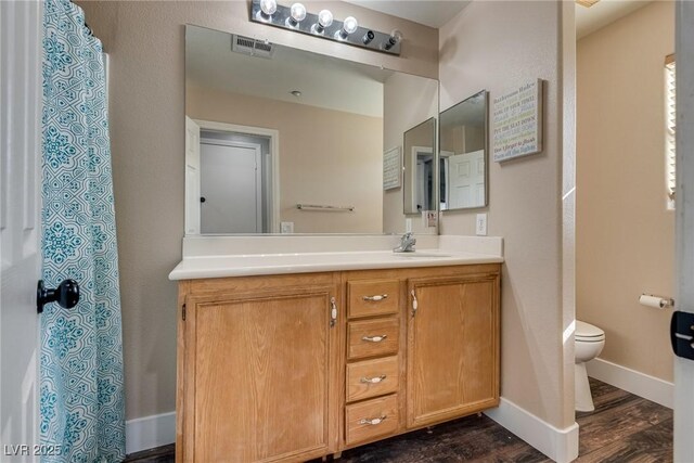 680 Moonlight Stroll St, Henderson, NV 89002 - bathroom featuring toilet, wood finished floors, vanity, and baseboards