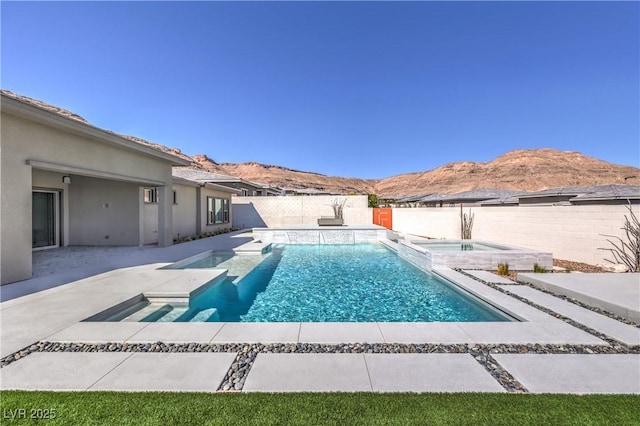 10048 Copper Edge Rd, Las Vegas, NV 89148 - view of swimming pool featuring a mountain view, a fenced backyard, a patio area, and a pool with connected hot tub
