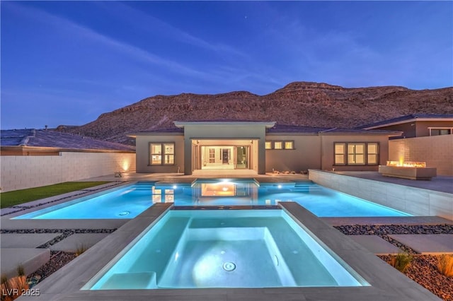 10048 Copper Edge Rd, Las Vegas, NV 89148 - view of swimming pool featuring an in-ground hot tub, a mountain view, a fire pit, and a patio area