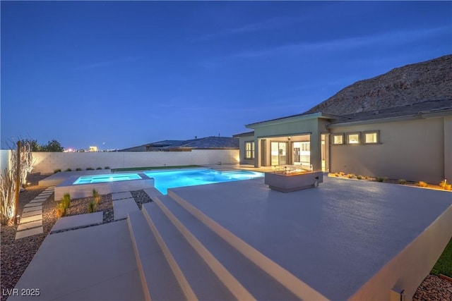 10048 Copper Edge Rd, Las Vegas, NV 89148 - pool at twilight with a patio area, a fenced backyard, and an in-ground hot tub