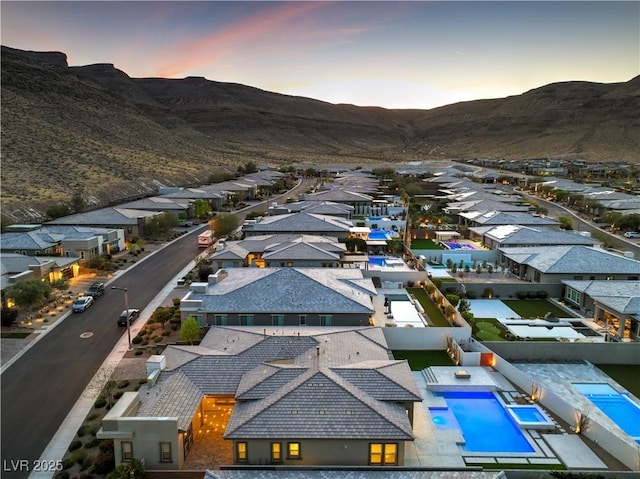 10048 Copper Edge Rd, Las Vegas, NV 89148 - aerial view at dusk of a mountain view, a residential view, and view of pool