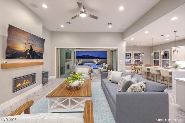 10048 Copper Edge Rd, Las Vegas, NV 89148 - living room with recessed lighting, a ceiling fan, and a glass covered fireplace