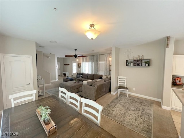8340 Winterchase Pl, Las Vegas, NV 89143 - dining room featuring light carpet, a ceiling fan, and baseboards