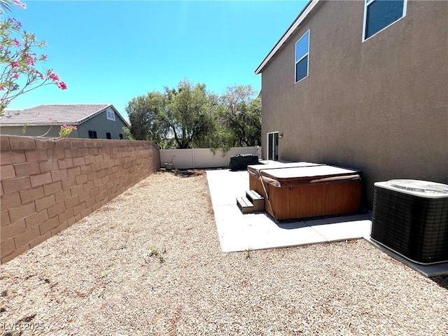 8340 Winterchase Pl, Las Vegas, NV 89143 - fenced backyard with a hot tub, central air condition unit, and a patio