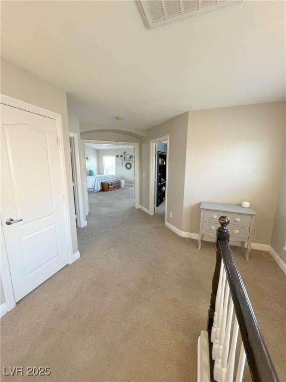 8340 Winterchase Pl, Las Vegas, NV 89143 - hallway with light carpet, arched walkways, and baseboards