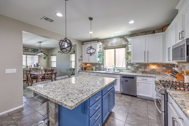 10623 Auburn Springs Ave, Las Vegas, NV 89166 - kitchen with appliances with stainless steel finishes, blue cabinetry, white cabinets, and recessed lighting