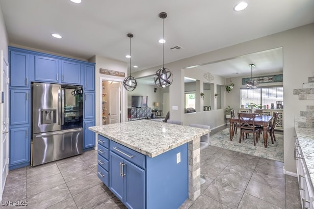 10623 Auburn Springs Ave, Las Vegas, NV 89166 - kitchen featuring stainless steel fridge, blue cabinets, a center island, recessed lighting, and hanging light fixtures