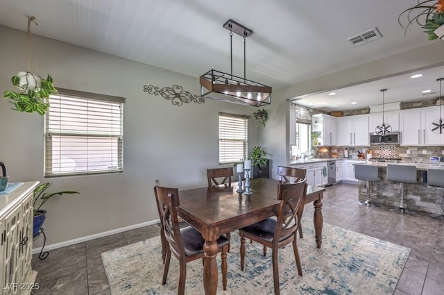 10623 Auburn Springs Ave, Las Vegas, NV 89166 - tiled dining space with baseboards, a sink, and recessed lighting
