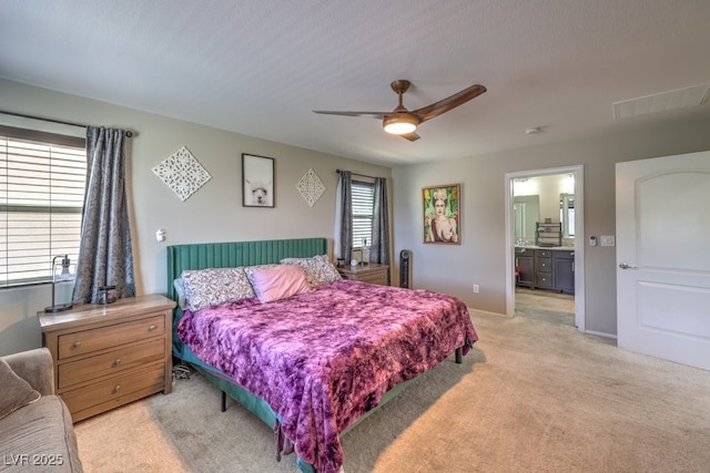 10623 Auburn Springs Ave, Las Vegas, NV 89166 - bedroom featuring light colored carpet, ensuite bathroom, ceiling fan, and baseboards