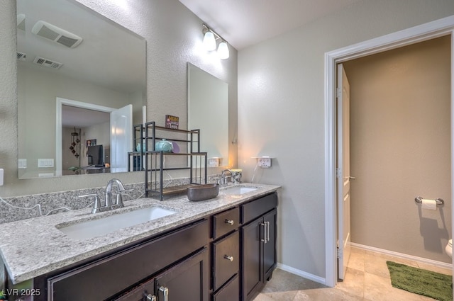 10623 Auburn Springs Ave, Las Vegas, NV 89166 - bathroom with double vanity, baseboards, and tile patterned flooring