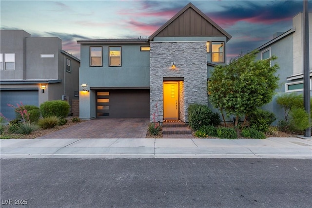 3206 Fountaintree Ave, Henderson, NV 89044 - contemporary house featuring stone siding, board and batten siding, decorative driveway, a garage, and stucco siding