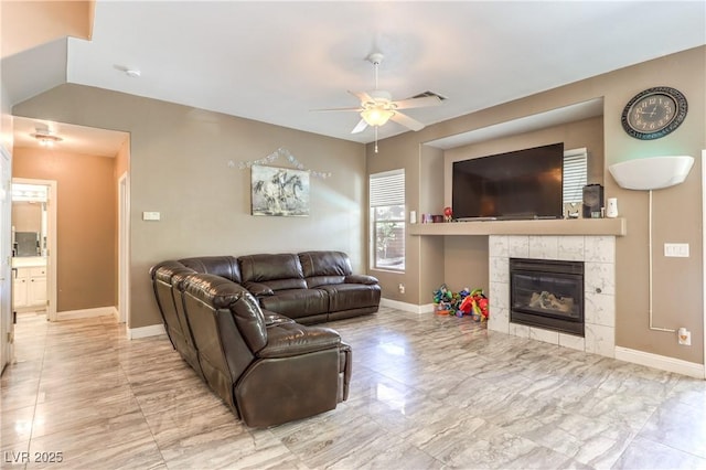 5862 Bluthe Bridge Ave, Las Vegas, NV 89141 - living room featuring ceiling fan, baseboards, and a tiled fireplace