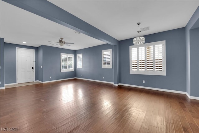 4063 Lower Saxon Ave, North Las Vegas, NV 89085 - spare room featuring a chandelier, wood finished floors, and ceiling fan