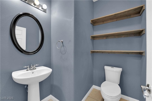 4063 Lower Saxon Ave, North Las Vegas, NV 89085 - half bath featuring toilet and tile patterned flooring