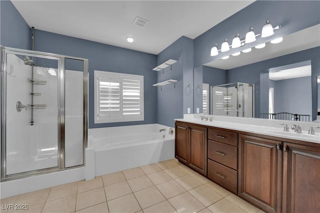 4063 Lower Saxon Ave, North Las Vegas, NV 89085 - full bathroom with a shower stall, a bath, double vanity, and tile patterned flooring