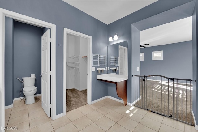 4063 Lower Saxon Ave, North Las Vegas, NV 89085 - bathroom featuring tile patterned floors, a walk in closet, and ceiling fan