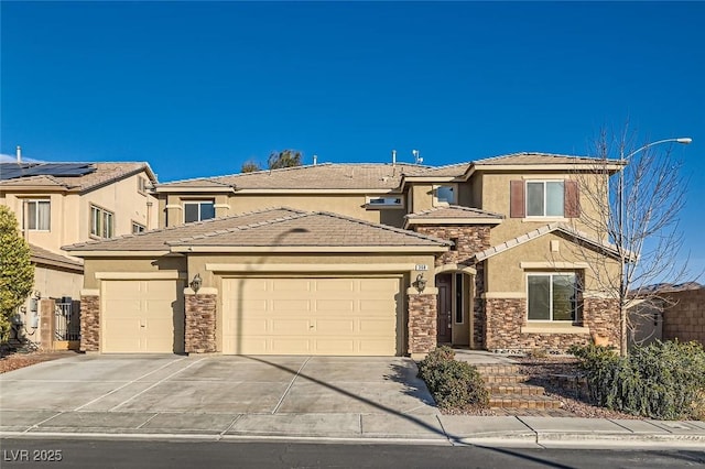 368 Misty Moonlight St, Henderson, NV 89015 - view of front of property with stucco siding, a garage, stone siding, and driveway