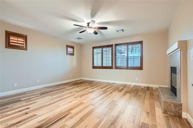 368 Misty Moonlight St, Henderson, NV 89015 - unfurnished living room with light wood-style flooring, ceiling fan, a fireplace, and baseboards
