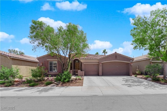 11244 Gammila Dr, Las Vegas, NV 89141 - mediterranean / spanish home with an attached garage, stucco siding, driveway, and a tiled roof