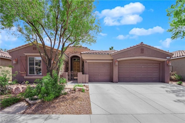 11244 Gammila Dr, Las Vegas, NV 89141 - mediterranean / spanish home with an attached garage, concrete driveway, stucco siding, and a tiled roof