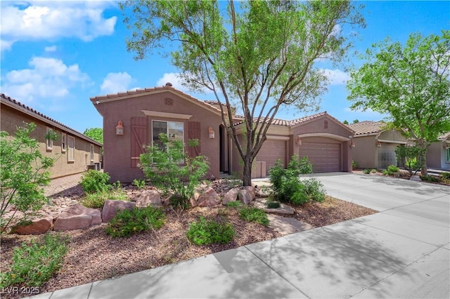 11244 Gammila Dr, Las Vegas, NV 89141 - mediterranean / spanish house featuring a garage, stucco siding, concrete driveway, and a tile roof