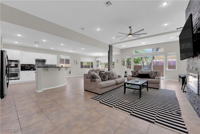 11244 Gammila Dr, Las Vegas, NV 89141 - living room with ceiling fan, a fireplace, recessed lighting, light tile patterned flooring, and baseboards