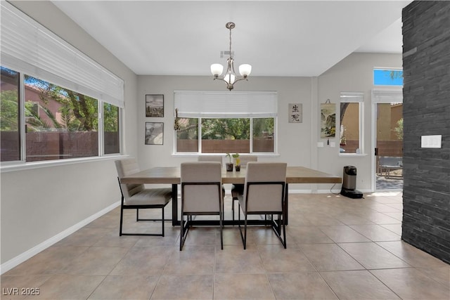 11244 Gammila Dr, Las Vegas, NV 89141 - dining area with a chandelier, healthy amount of natural light, light tile patterned flooring, and baseboards