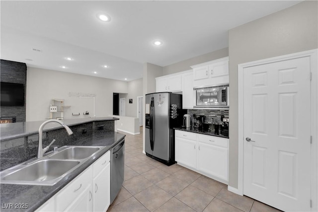 11244 Gammila Dr, Las Vegas, NV 89141 - kitchen with stainless steel appliances, a sink, dark countertops, tasteful backsplash, and white cabinets