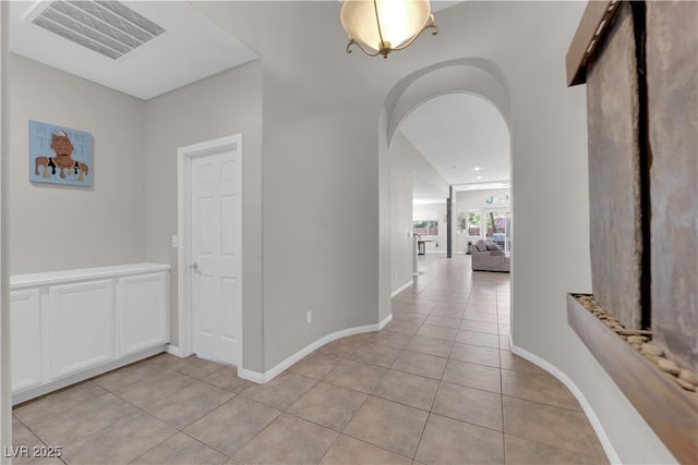 11244 Gammila Dr, Las Vegas, NV 89141 - hallway with light tile patterned floors, arched walkways, and baseboards