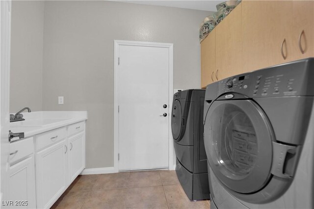 11244 Gammila Dr, Las Vegas, NV 89141 - washroom featuring cabinet space, separate washer and dryer, light tile patterned floors, and baseboards