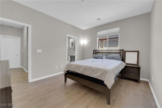 11244 Gammila Dr, Las Vegas, NV 89141 - bedroom featuring baseboards, light wood-style floors, and ensuite bathroom