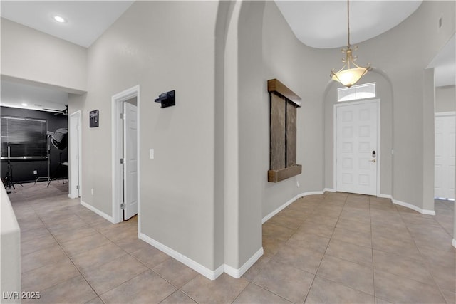 11244 Gammila Dr, Las Vegas, NV 89141 - entryway with light tile patterned floors, baseboards, and a towering ceiling