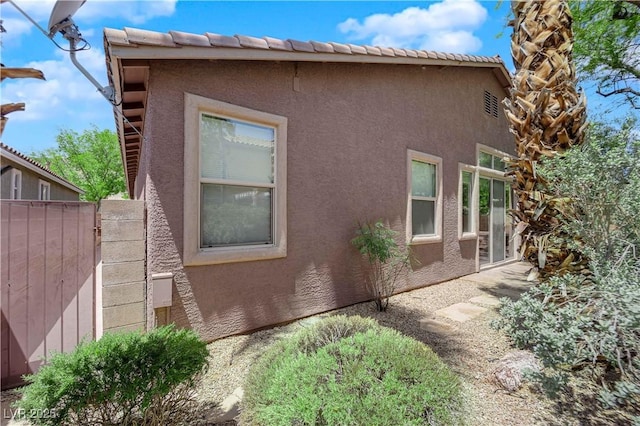 11244 Gammila Dr, Las Vegas, NV 89141 - view of side of home with stucco siding, a gate, and fence