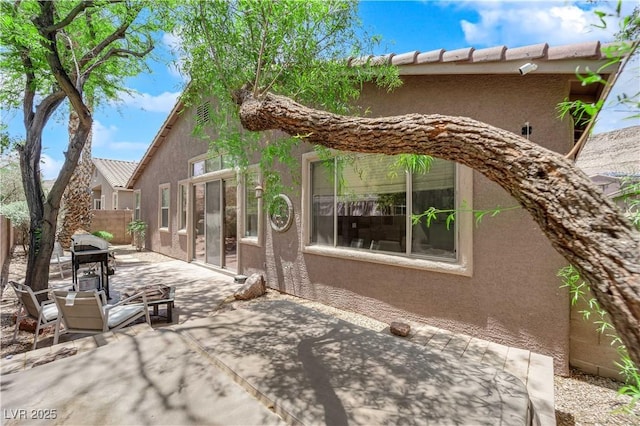11244 Gammila Dr, Las Vegas, NV 89141 - view of side of property featuring stucco siding, a patio, and fence