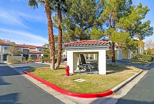 8455 W Sahara Ave Unit 213, Las Vegas, NV 89117 - mediterranean / spanish house with a tiled roof, stucco siding, and a front yard
