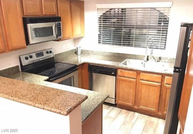8455 W Sahara Ave Unit 213, Las Vegas, NV 89117 - kitchen with stainless steel appliances, a sink, and light stone countertops