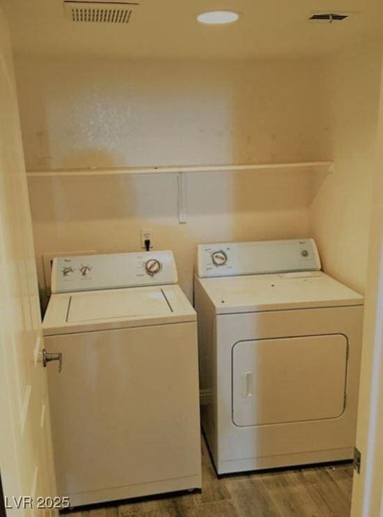 8455 W Sahara Ave Unit 213, Las Vegas, NV 89117 - washroom with separate washer and dryer and light wood-style floors
