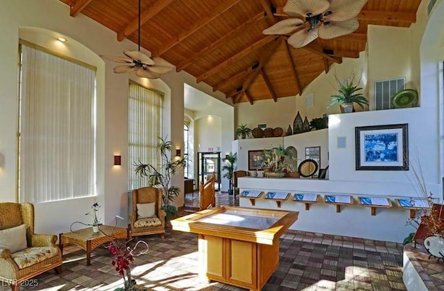 8455 W Sahara Ave Unit 213, Las Vegas, NV 89117 - living area featuring a ceiling fan, wooden ceiling with exposed beams, high vaulted ceiling, and dark colored carpet