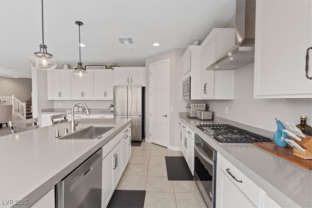 10324 Stroma Ave, Las Vegas, NV 89166 - kitchen featuring stainless steel appliances, a sink, wall chimney range hood, light countertops, and recessed lighting